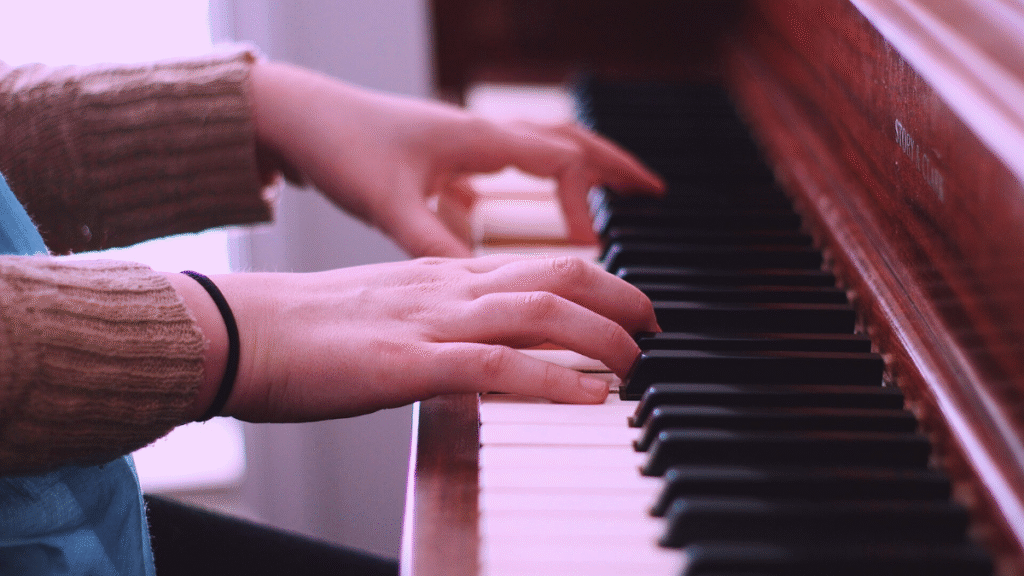 He plays the piano with both hands